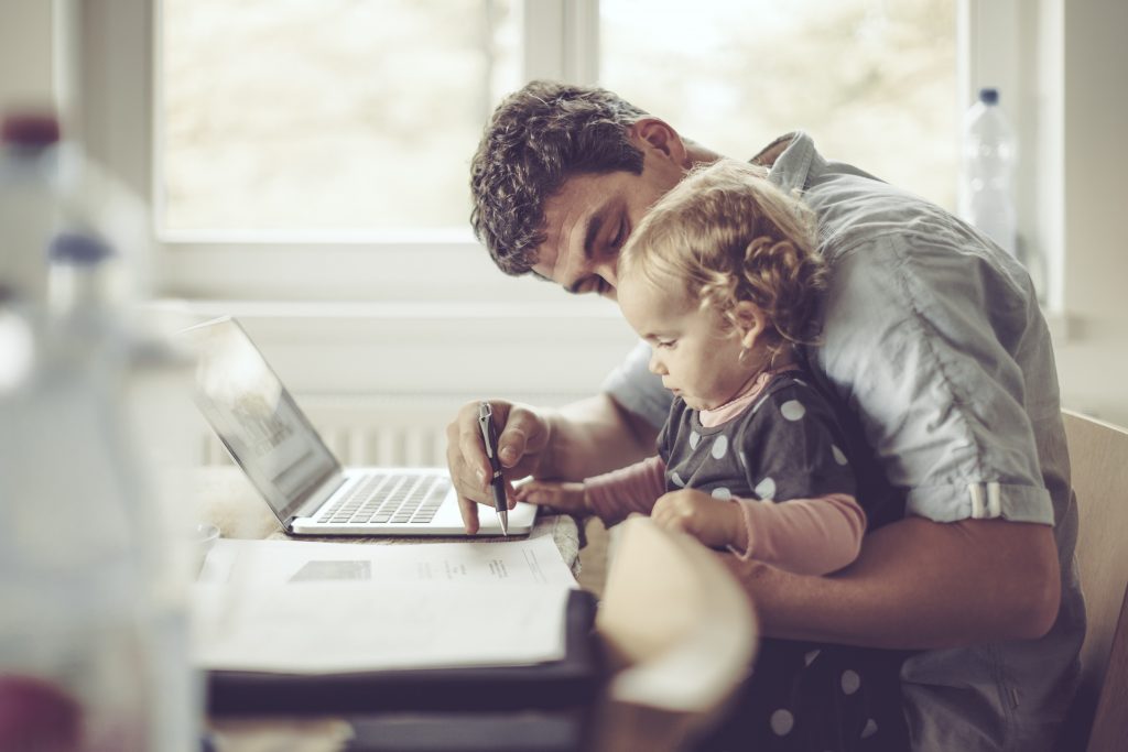 Father showing young child how to use computer