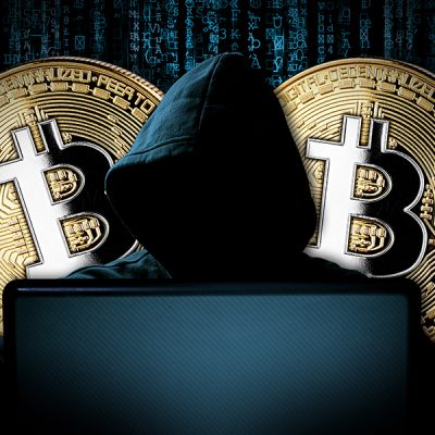 hacker with bitcoins behind notebook laptop in front of blue source binary code background internet cyber hack attack crypto currency blockchain computer concept