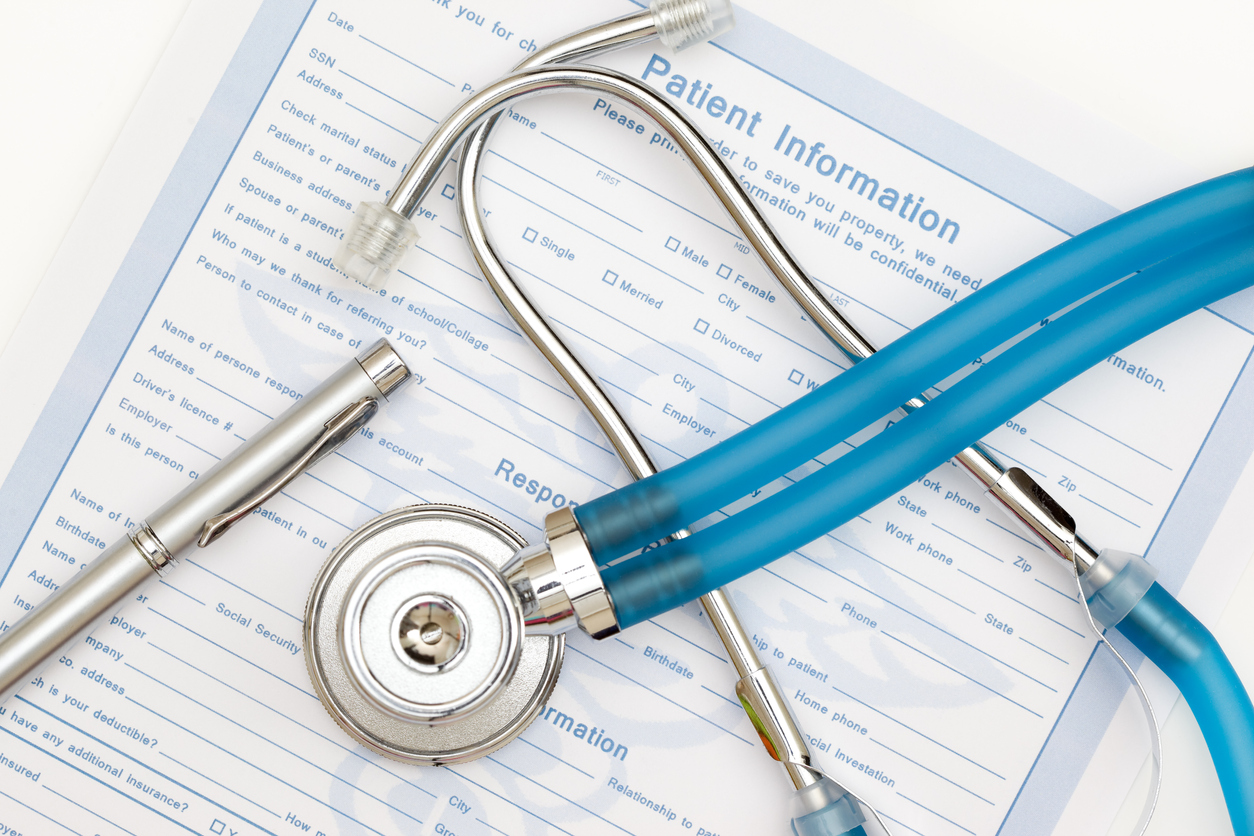patient information paperwork with stethoscope laying on top