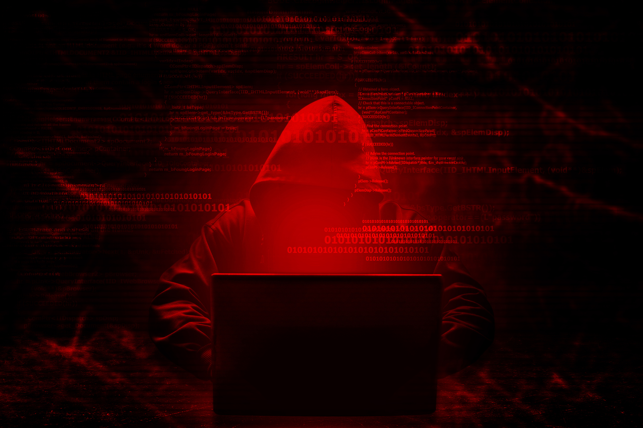 hacker behind laptop